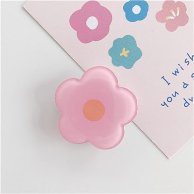 Cartoon Flower Phone Socket. Attach these to your phone so you can hold it securely, prop it up whilst watching shows, or just fiddle around with it. Compatible with any phone!