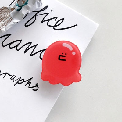 Cartoon Squid Phone Socket. Attach these to your phone so you can hold it securely, prop it up whilst watching shows, or just fiddle around with it. Compatible with any phone!