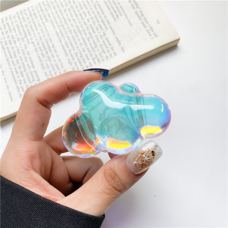 Holographic Clouds Phone Socket. Attach these to your phone so you can hold it securely, prop it up whilst watching shows, or just fiddle around with it. Compatible with any phone!