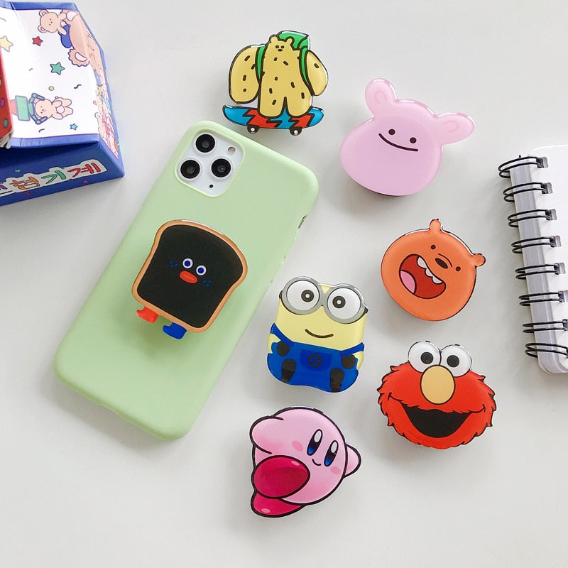 Cartoon Phone Socket. Griptok. Attach it to your phone so you can hold it securely, prop it up whilst watching shows, or just fiddle around with it. Compatible with any phone!