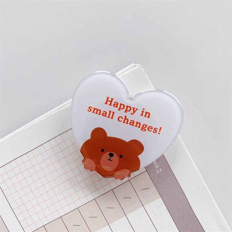 Assurance Bear Cartoon Phone Socket. Griptok. Attach it to your phone so you can hold it securely, prop it up whilst watching shows, or just fiddle around with it. Compatible with any phone!