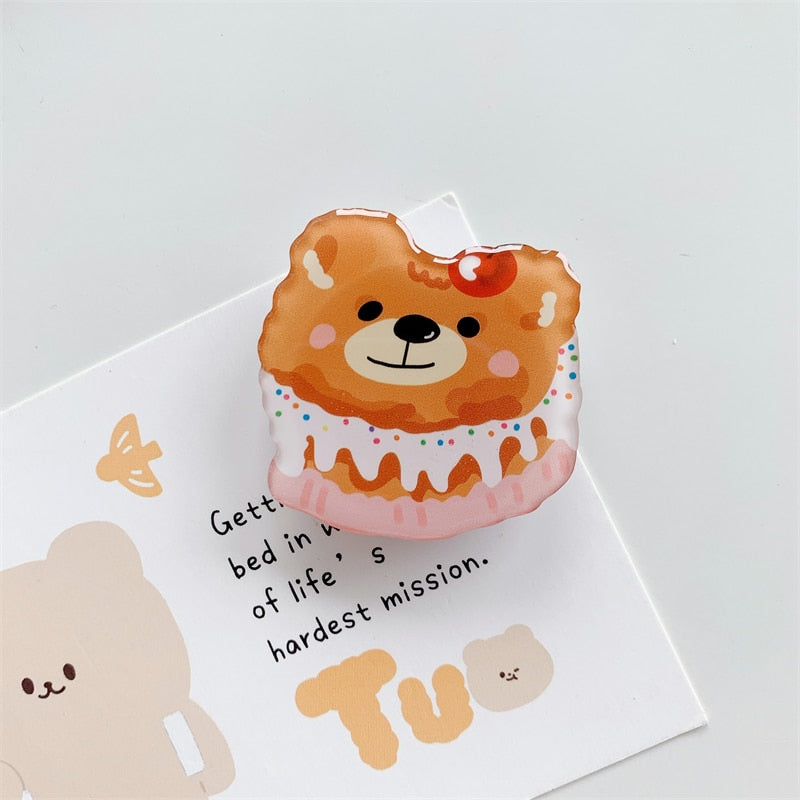 Bear Cake Cartoon Phone Socket. Griptok. Attach it to your phone so you can hold it securely, prop it up whilst watching shows, or just fiddle around with it. Compatible with any phone!