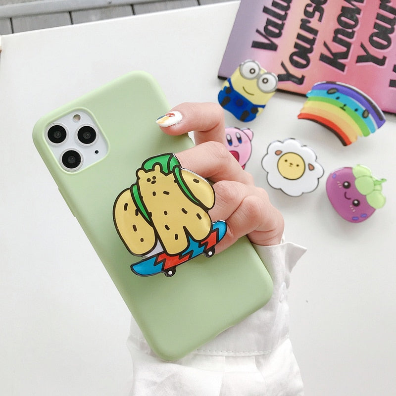 Cartoon Phone Socket. Griptok. Attach it to your phone so you can hold it securely, prop it up whilst watching shows, or just fiddle around with it. Compatible with any phone!