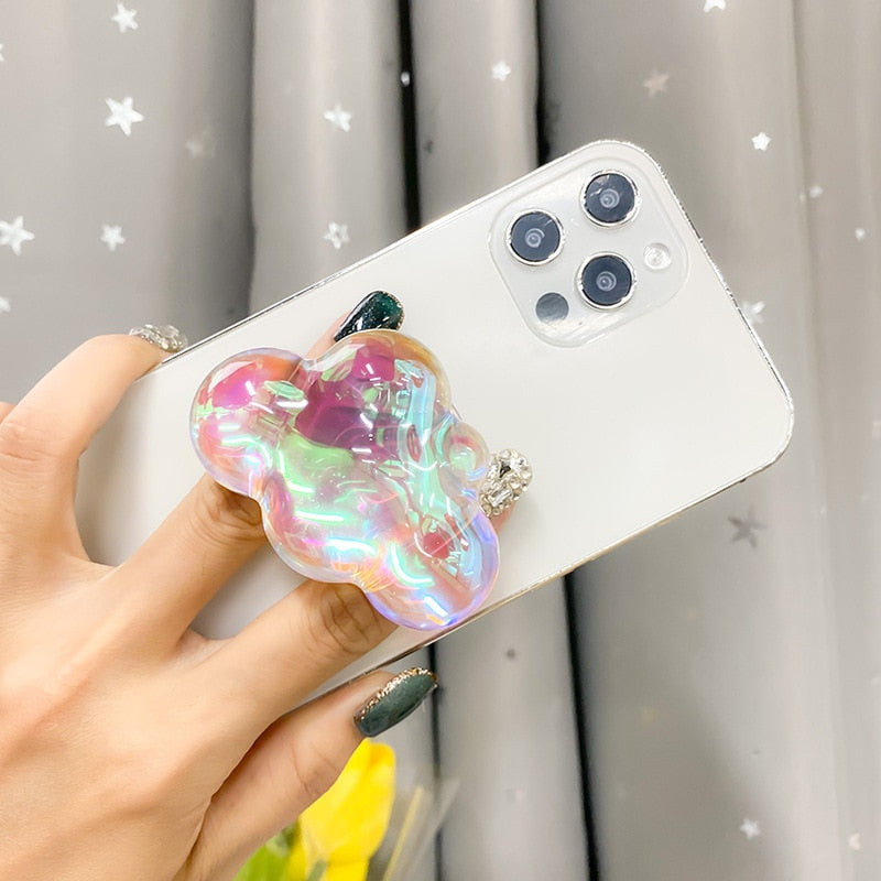 Holographic Clouds Phone Socket. Attach these to your phone so you can hold it securely, prop it up whilst watching shows, or just fiddle around with it. Compatible with any phone!