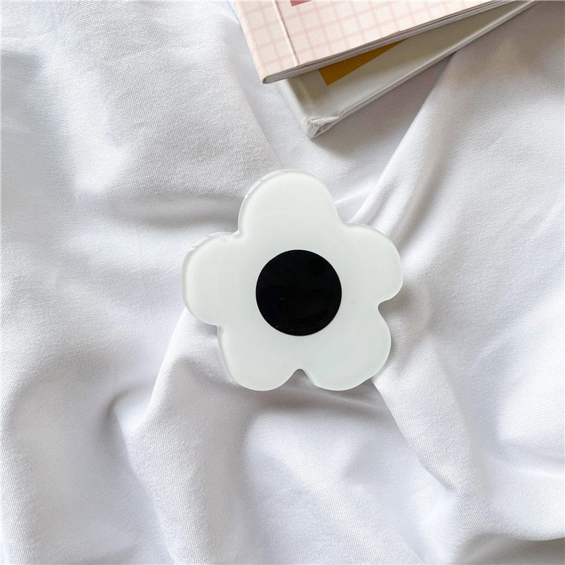 Cartoon Flower Phone Socket. Attach these to your phone so you can hold it securely, prop it up whilst watching shows, or just fiddle around with it.  Compatible with any phone!