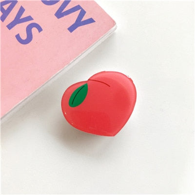 Cartoon Peach Phone Socket. Attach these to your phone so you can hold it securely, prop it up whilst watching shows, or just fiddle around with it.  Compatible with any phone!