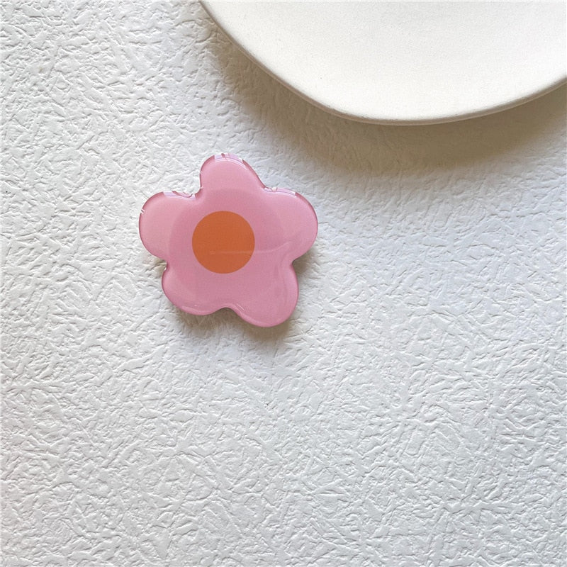 Cartoon Flower Phone Socket. Attach these to your phone so you can hold it securely, prop it up whilst watching shows, or just fiddle around with it.  Compatible with any phone!