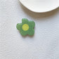 Cartoon Flower Phone Socket. Attach these to your phone so you can hold it securely, prop it up whilst watching shows, or just fiddle around with it.  Compatible with any phone!
