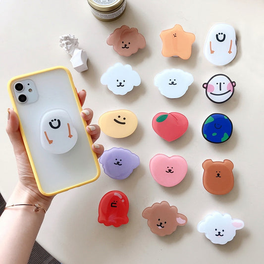 Cartoon Phone Socket. Attach these to your phone so you can hold it securely, prop it up whilst watching shows, or just fiddle around with it.  Compatible with any phone!