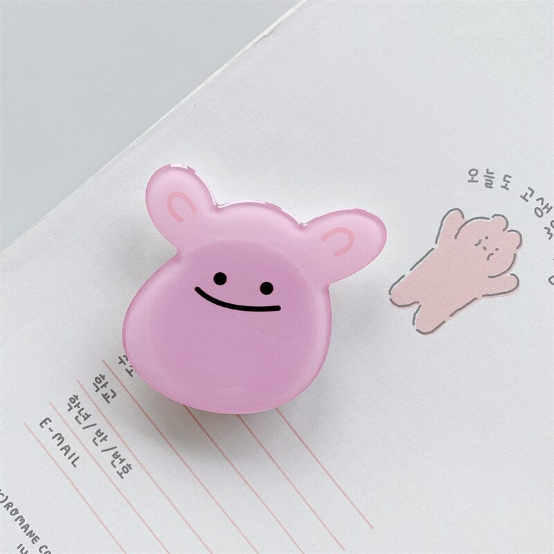 Derp Cartoon Phone Socket. Griptok. Attach it to your phone so you can hold it securely, prop it up whilst watching shows, or just fiddle around with it. Compatible with any phone!