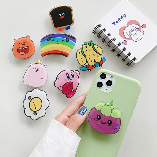 Cartoon Phone Socket. Griptok. Attach it to your phone so you can hold it securely, prop it up whilst watching shows, or just fiddle around with it. Compatible with any phone!