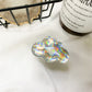 Holographic Clouds Phone Socket. Attach these to your phone so you can hold it securely, prop it up whilst watching shows, or just fiddle around with it.  Compatible with any phone!