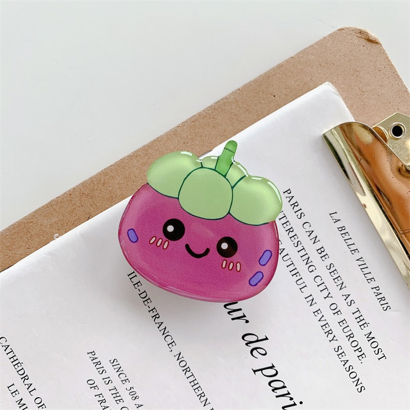 Mangosteen Cartoon Phone Socket. Griptok. Attach it to your phone so you can hold it securely, prop it up whilst watching shows, or just fiddle around with it. Compatible with any phone!