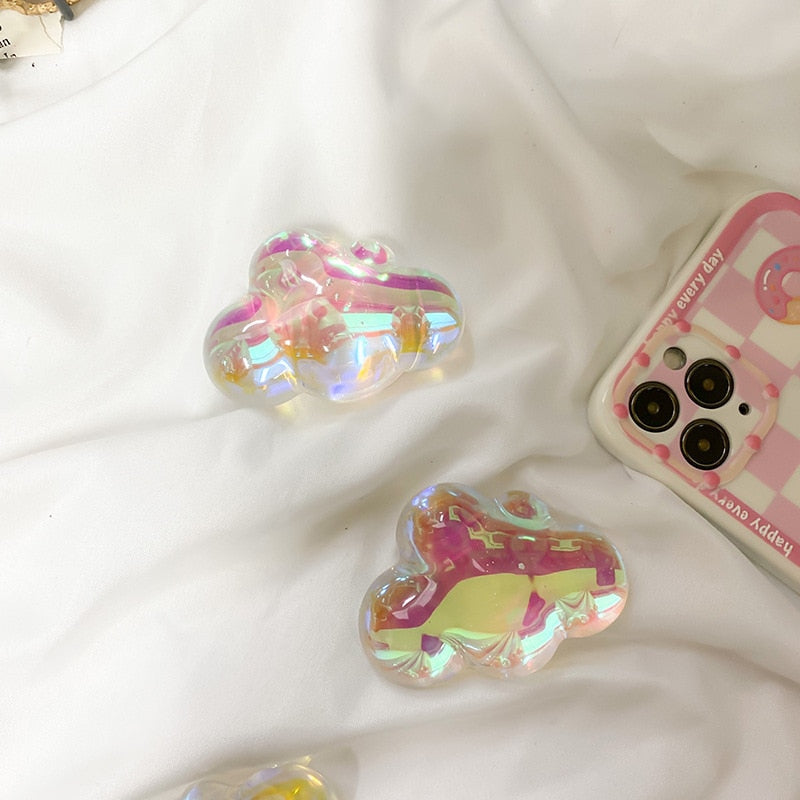 Holographic Clouds Phone Socket. Attach these to your phone so you can hold it securely, prop it up whilst watching shows, or just fiddle around with it.  Compatible with any phone!
