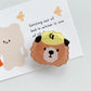 Bear Cartoon Phone Socket. Griptok. Attach it to your phone so you can hold it securely, prop it up whilst watching shows, or just fiddle around with it. Compatible with any phone!