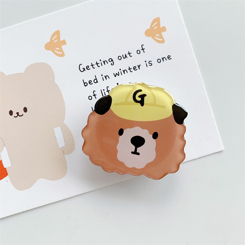 Bear Cartoon Phone Socket. Griptok. Attach it to your phone so you can hold it securely, prop it up whilst watching shows, or just fiddle around with it. Compatible with any phone!