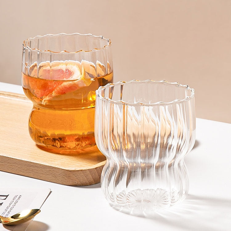 Curvy glass cup with vertical stripes, perfect size for your hands with a non-slip design, stackable shape. Heat resistant glass material too! 