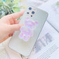 Pink Phone Pop Socket Bear. Attach it to your phone so you can hold it securely, prop it up whilst watching shows, or just fiddle around with it. Compatible with any phone!