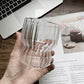 Curvy glass cup with vertical stripes, perfect size for your hands with a non-slip design, stackable shape. Heat resistant glass material too! 