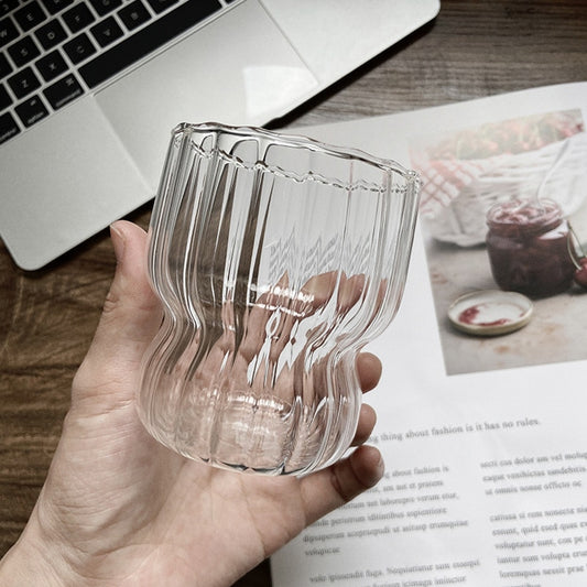 Curvy glass cup with vertical stripes, perfect size for your hands with a non-slip design, stackable shape. Heat resistant glass material too! 