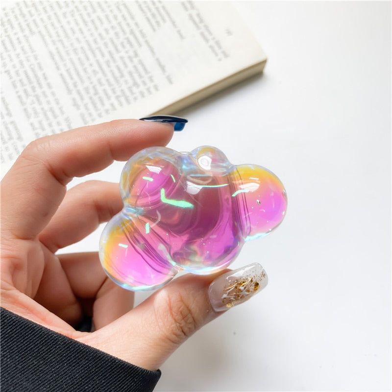 Holographic Clouds Phone Socket. Attach these to your phone so you can hold it securely, prop it up whilst watching shows, or just fiddle around with it.  Compatible with any phone!