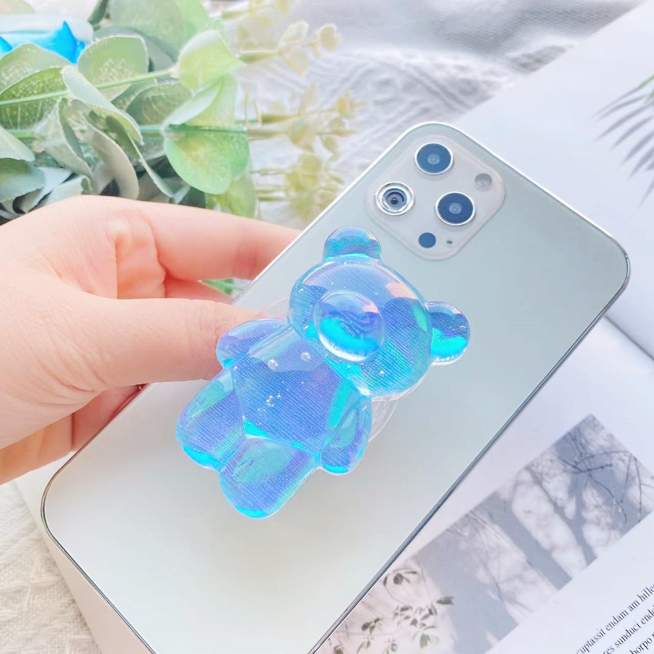 Blue Phone Pop Socket Bear. Attach it to your phone so you can hold it securely, prop it up whilst watching shows, or just fiddle around with it. Compatible with any phone!